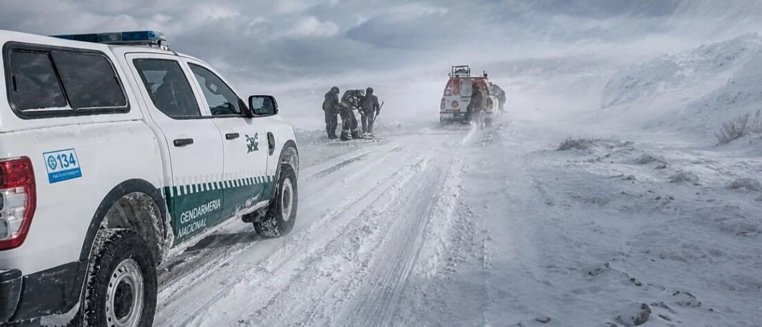 Camionetas de Gendarmería y personal de rescate en una ruta cubierta de nieve, en el marco de Río Tinto bajo investigación por el accidente de los mineros de Fénix varados en la nieve.
